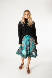 Sophie is wearing a silk wrap skirt in morning dew 