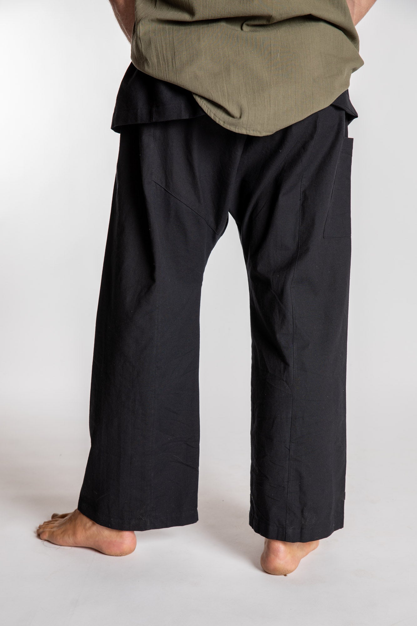 Topher is wearing the Black Thai Fisherman Pocket Pants 