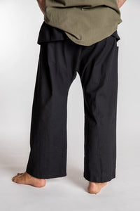 Topher is wearing the Black Thai Fisherman Pocket Pants 