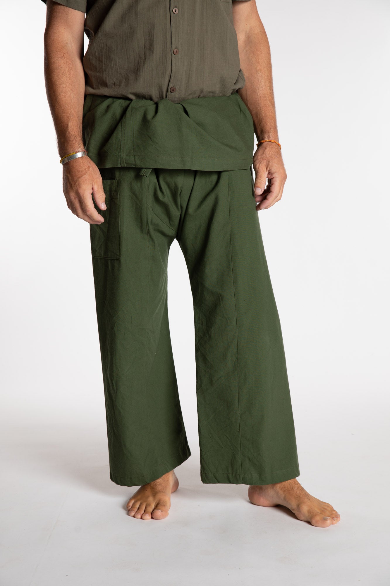 Topher is wearing the Olive Thai Fisherman Pocket Pants 