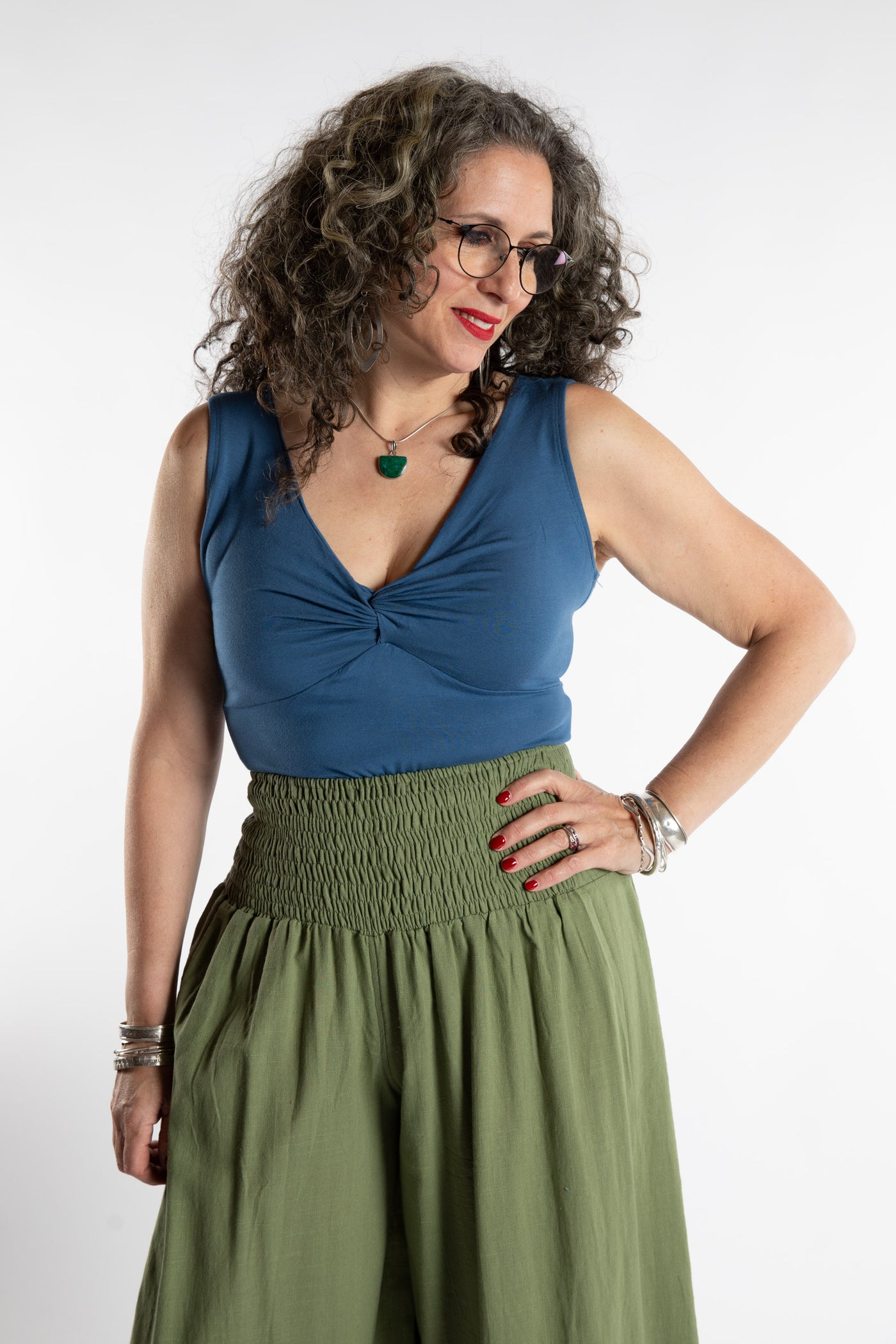 Susan is wearing the Twist Front Tank in Ocean in M/L
