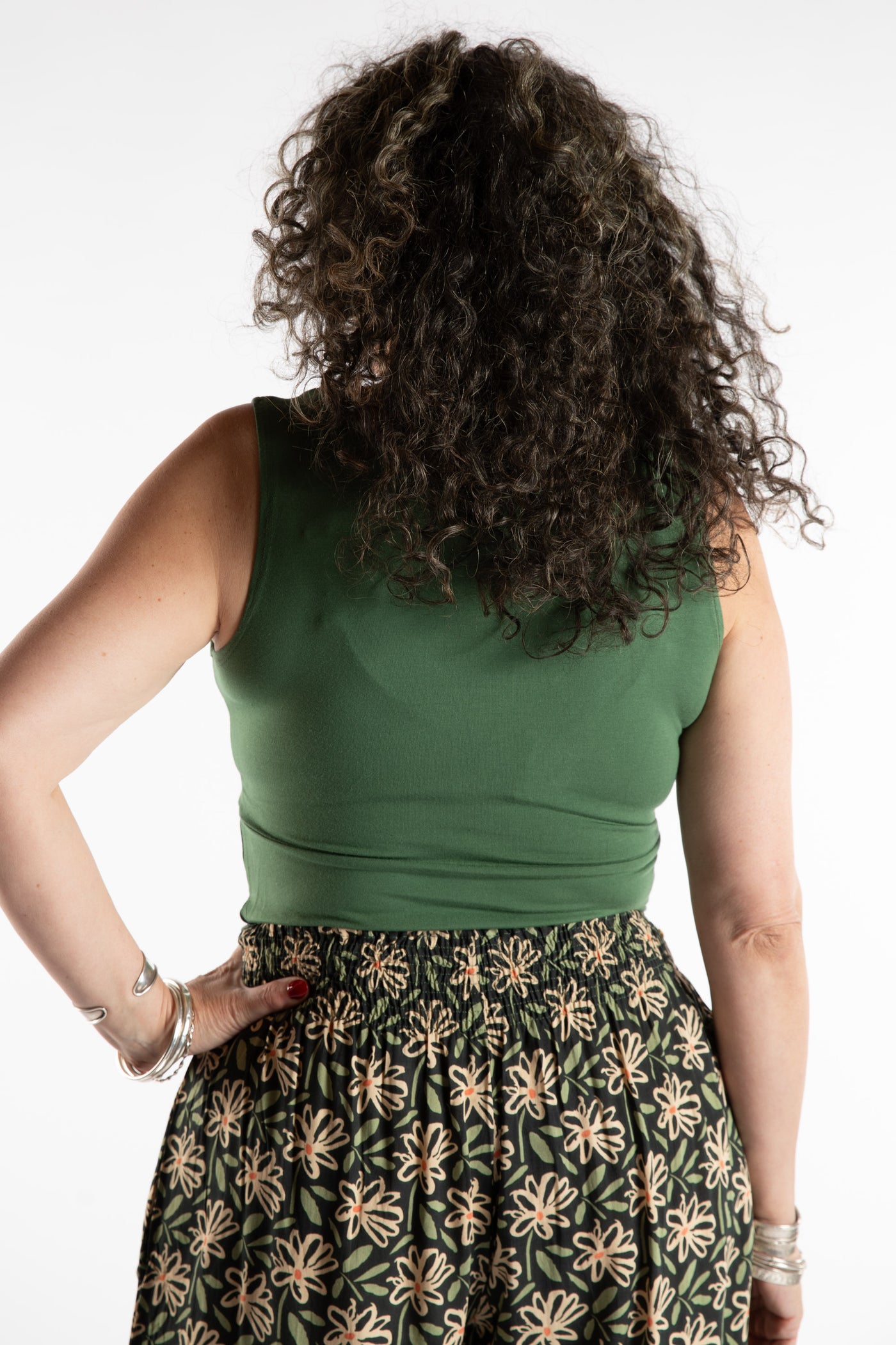 Susan is wearing the Twist Front Tank in Olive in M/L