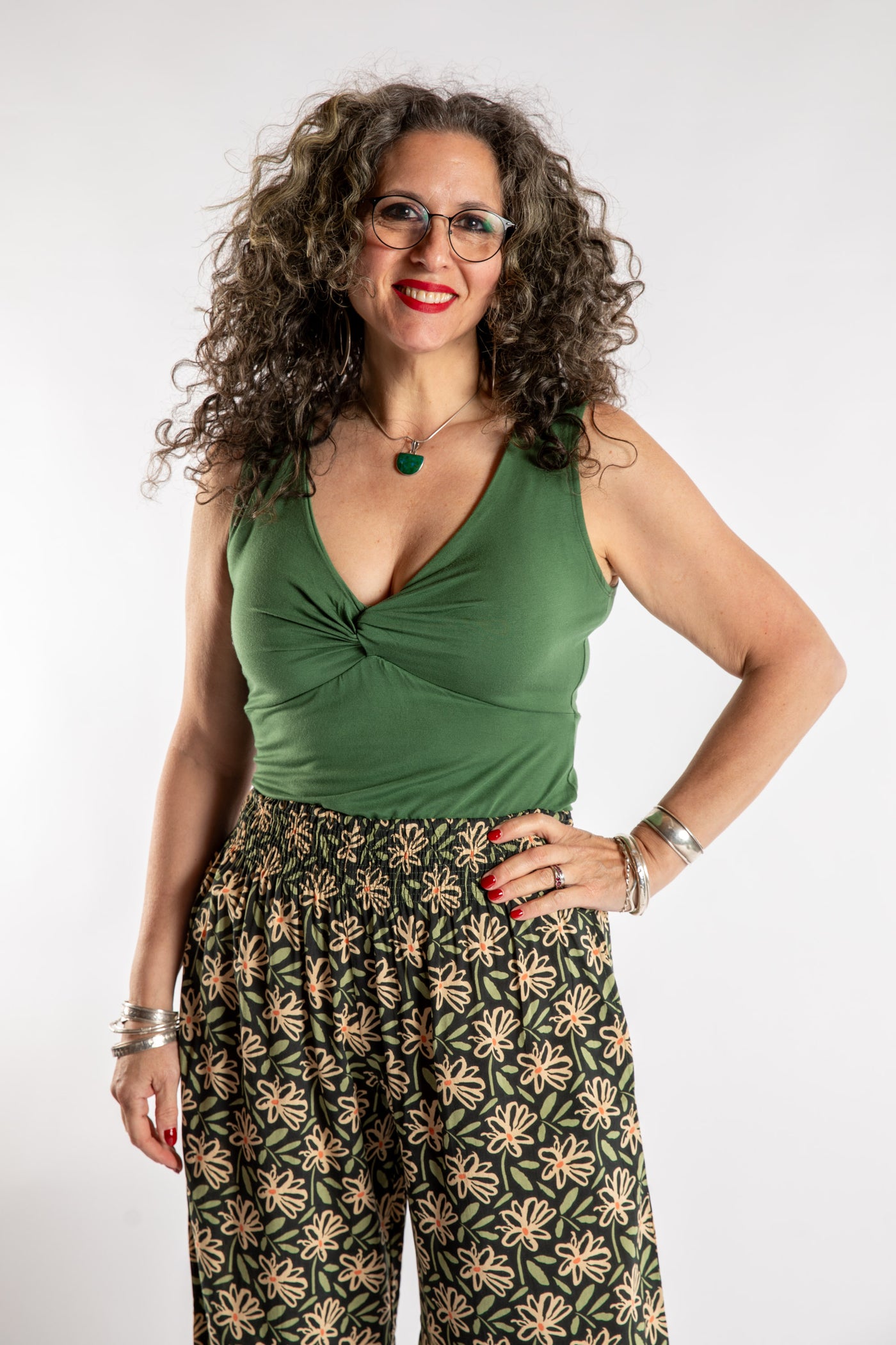 Susan is wearing the Twist Front Tank in Olive in M/L