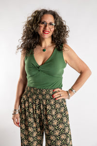 Susan is wearing the Twist Front Tank in Olive in M/L