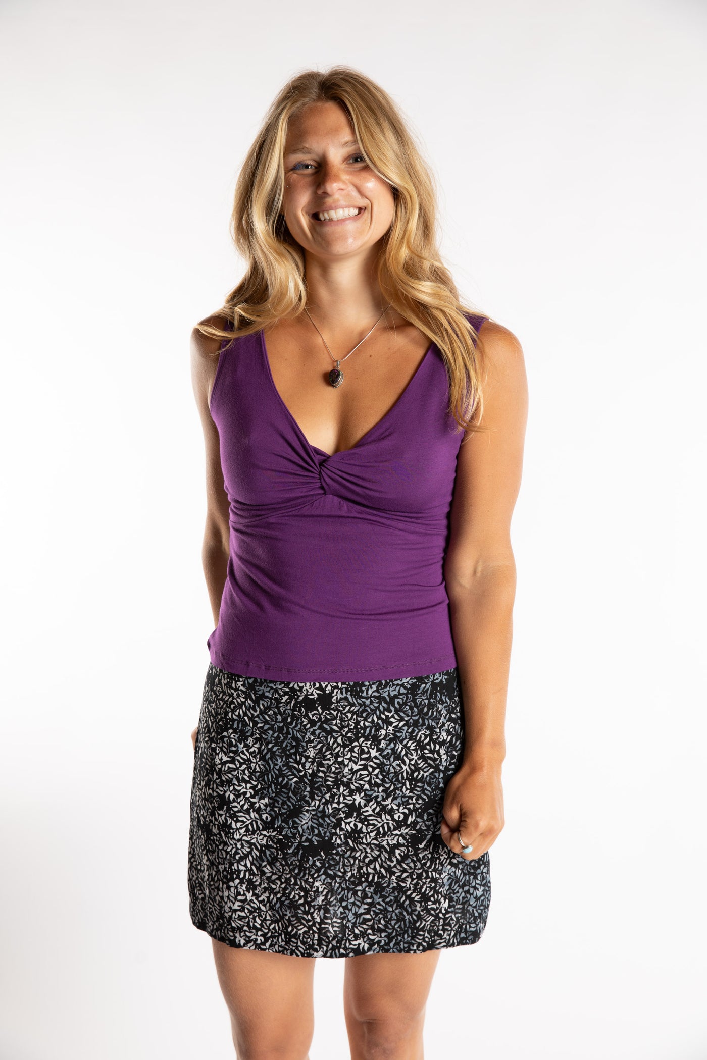 Sophie is wearing size S/M Women's Tank Top in Purple with batik skirt