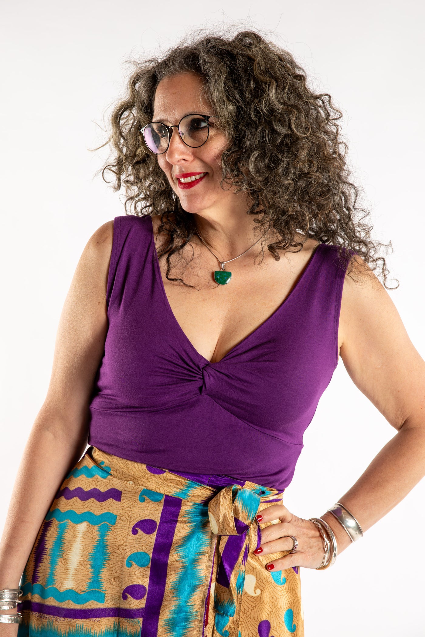 Susan is wearing the Twist Front Tank in Purple in M/L