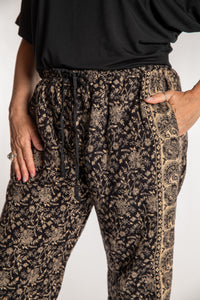 Susan is wearing the L/XL Veda Soft Brushed Pants in Black