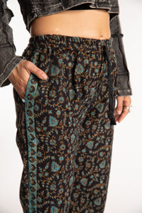 Sophie is wearing the S/M Veda Soft Brushed Pants in Black and Blue