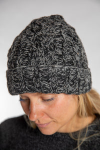Sophie is wearing the Wharfside Cable Knit Wool Beanie in Black Space Dye