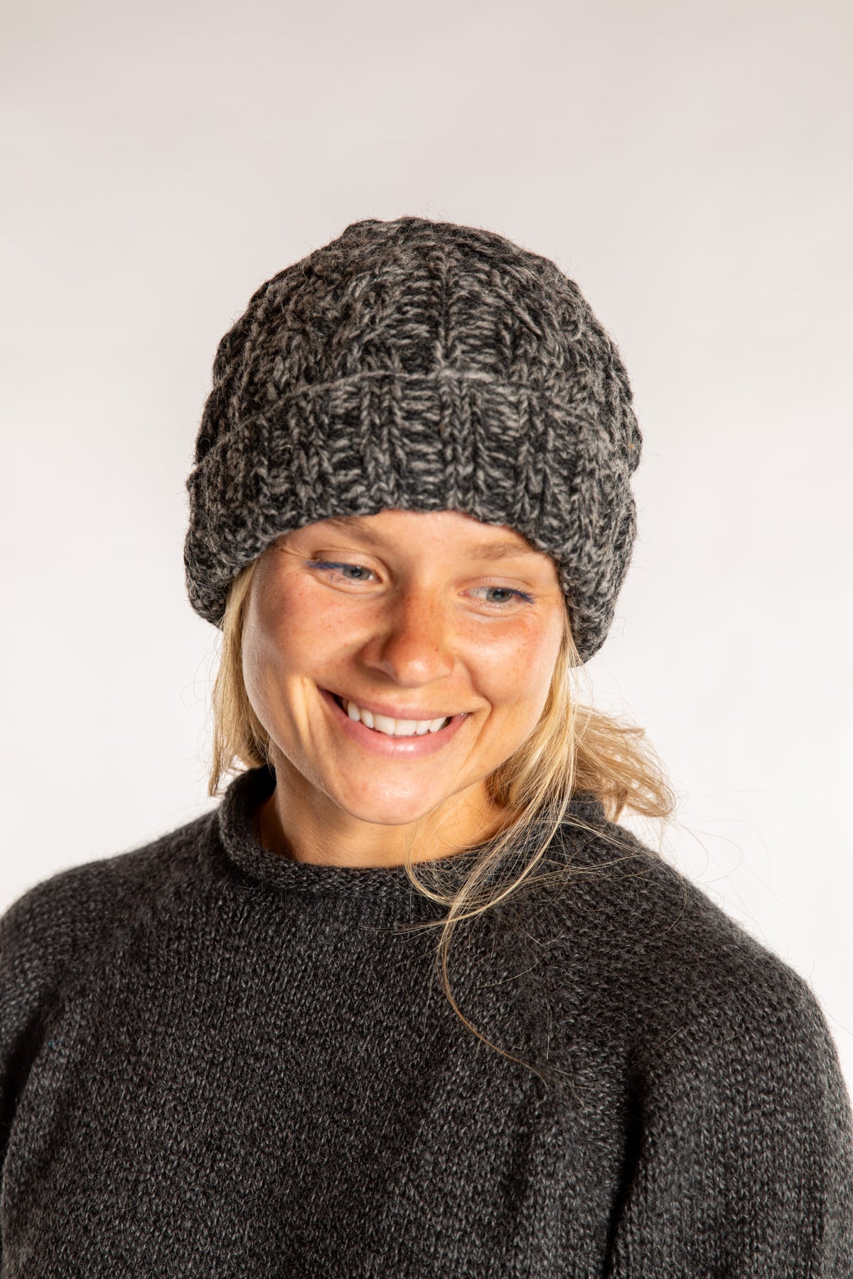 Sophie is wearing the Wharfside Cable Knit Wool Beanie in Black Space Dye