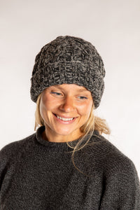 Sophie is wearing the Wharfside Cable Knit Wool Beanie in Black Space Dye