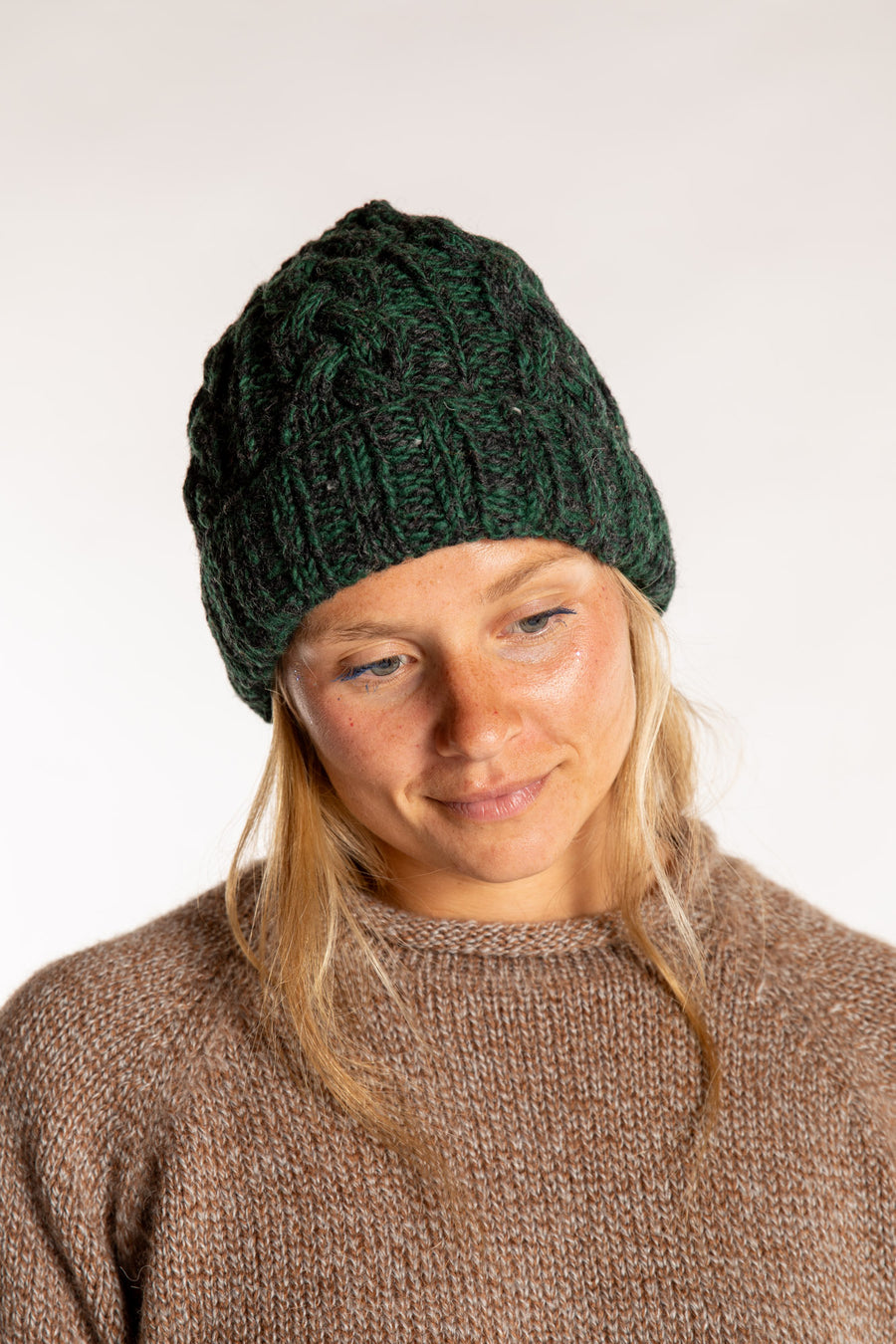 Sophie is wearing the Wharfside Cable Knit Wool Beanie in Forest Green 