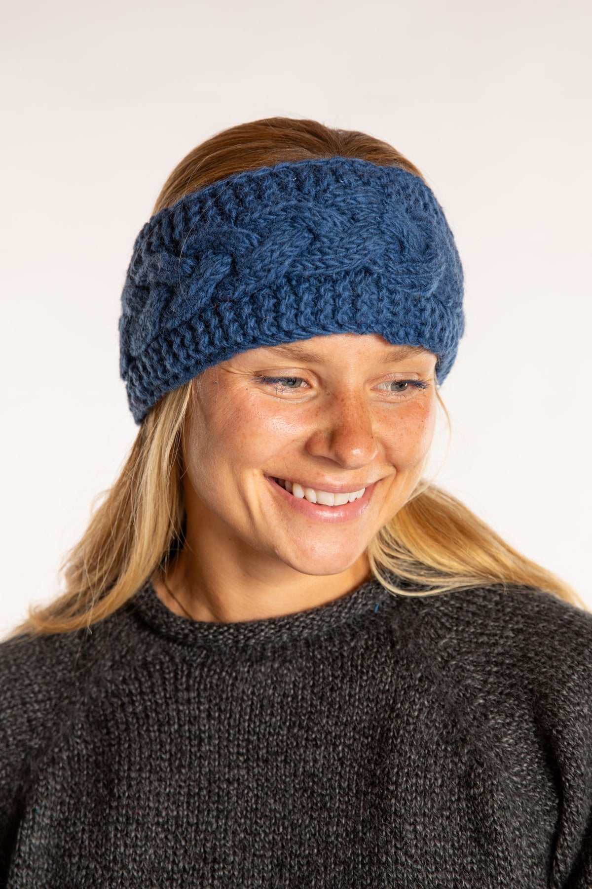 Sophie is wearing the Wharfside Cable Knit Wool Headband in Blue