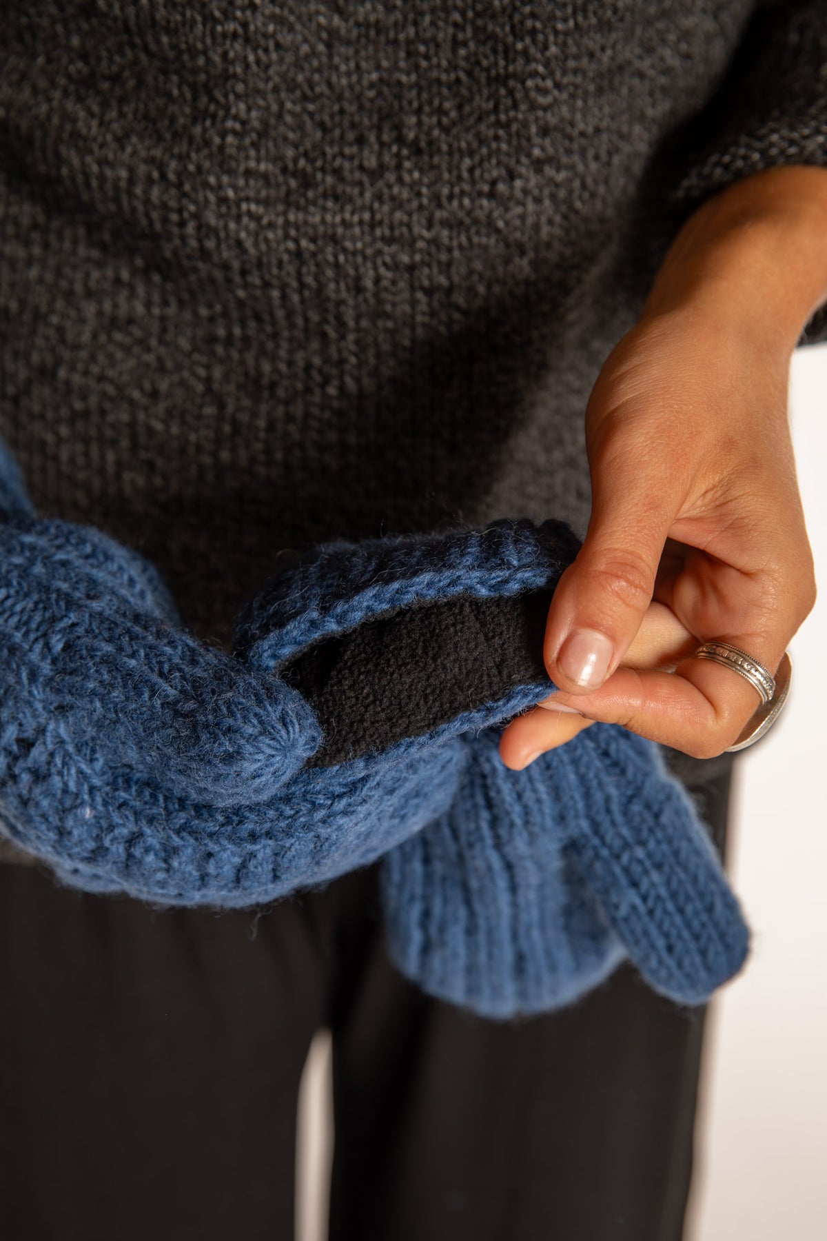 Sophie is wearing the Wharfside Cable Knit Wool Mittens in Blue
