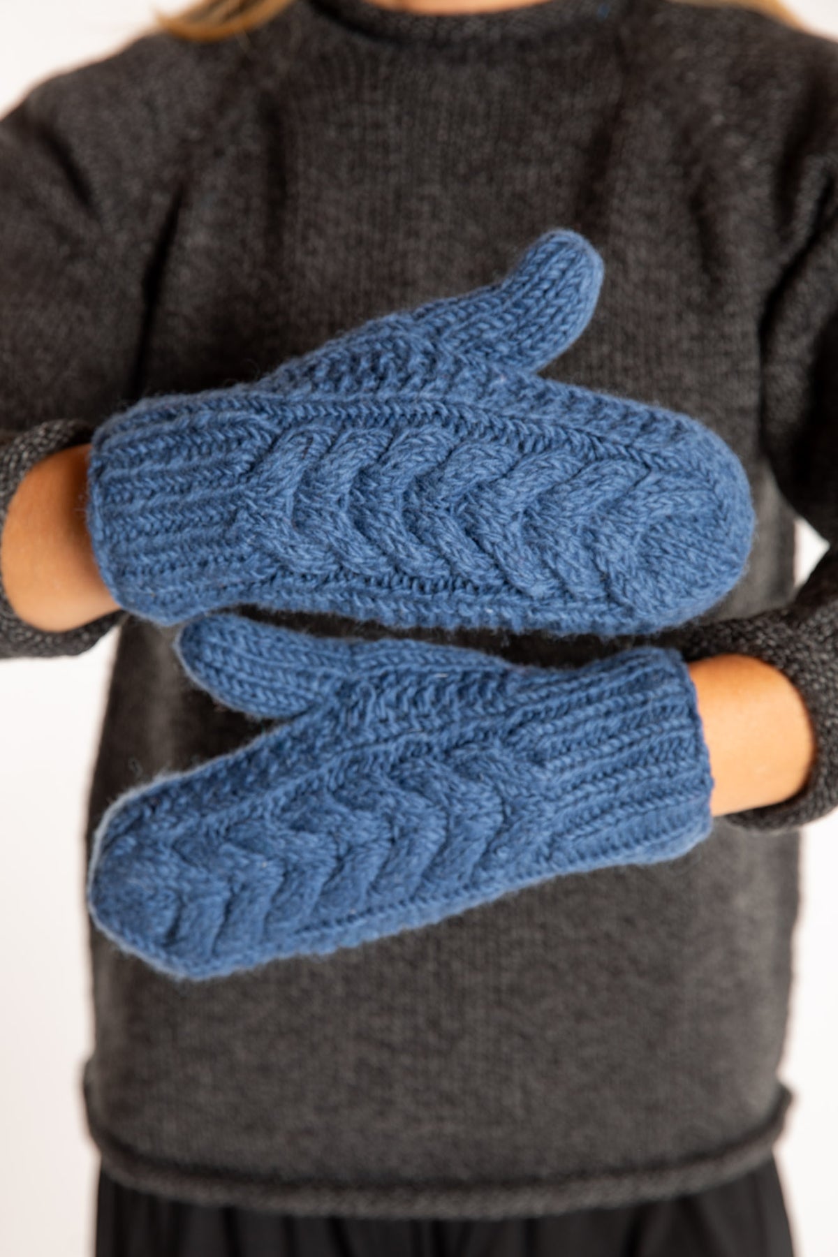 Sophie is wearing the Wharfside Cable Knit Wool Mittens in Blue
