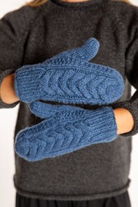 Sophie is wearing the Wharfside Cable Knit Wool Mittens in Blue