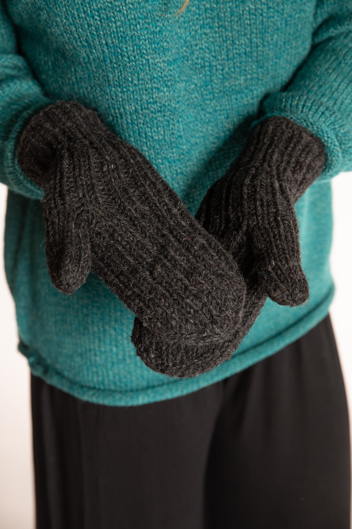 Sophie is wearing the Wharfside Cable Knit Wool Mittens in Charcoal