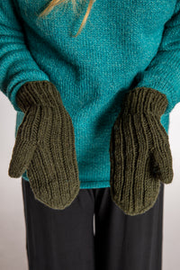 Sophie is wearing the Wharfside Cable Knit Wool Mittens in Olive