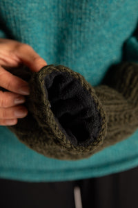 Sophie is wearing the Wharfside Cable Knit Wool Mittens in Olive