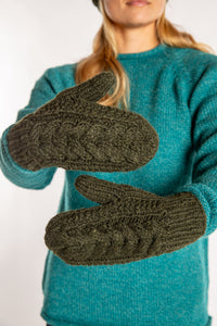 Sophie is wearing the Wharfside Cable Knit Wool Mittens in Olive