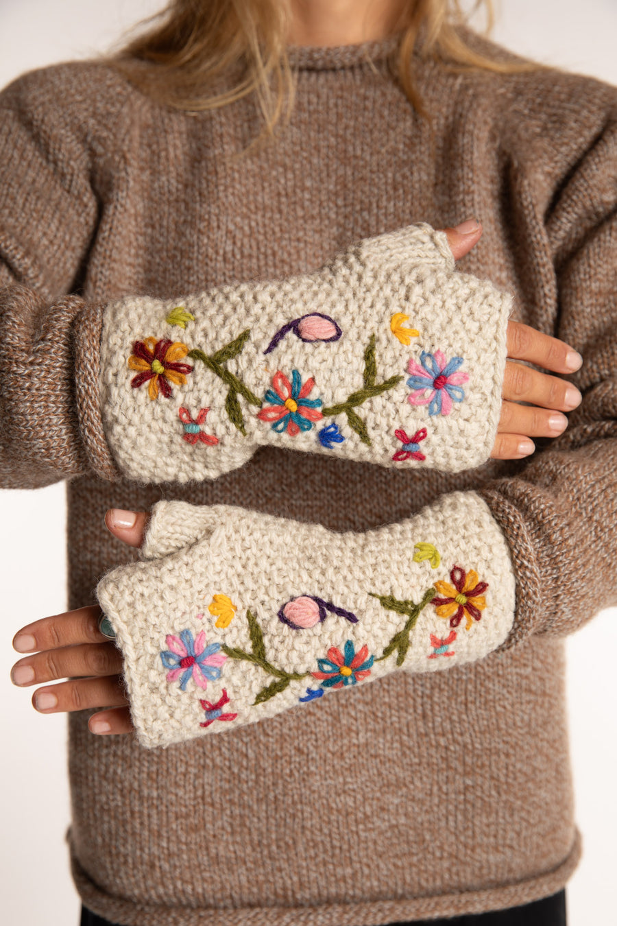 Sophie is wearing the Wildflower Embroidered Wool Fingerless Mittens in White