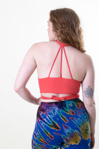 Carly is wearing size S wrap top in coral