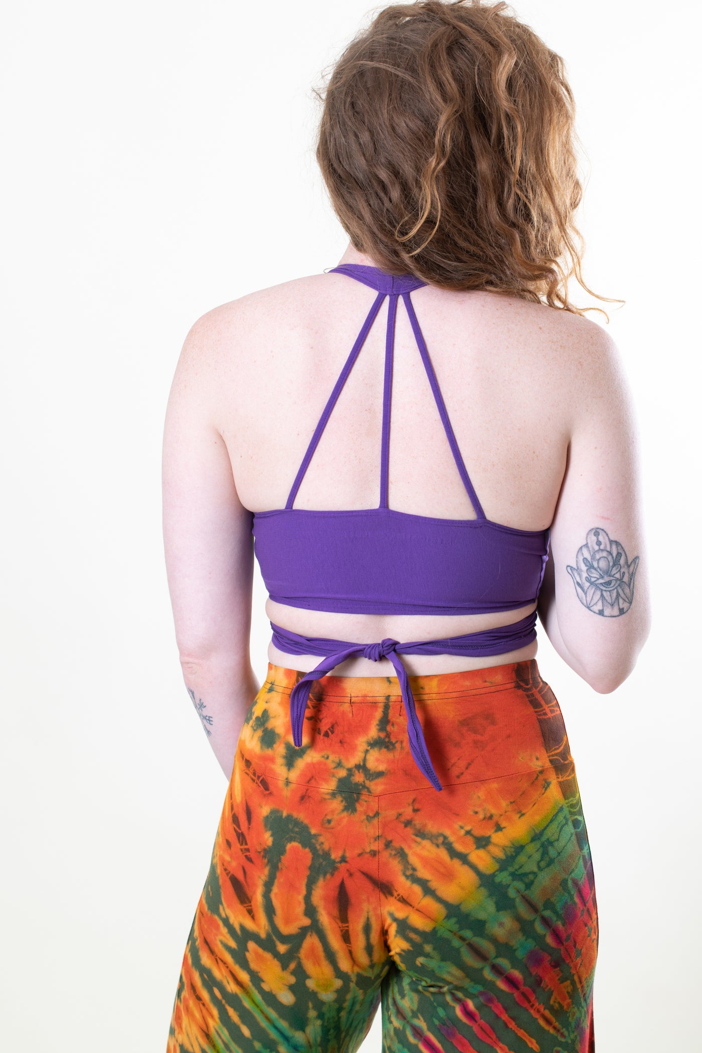 Carly is wearing size S wrap top in plum