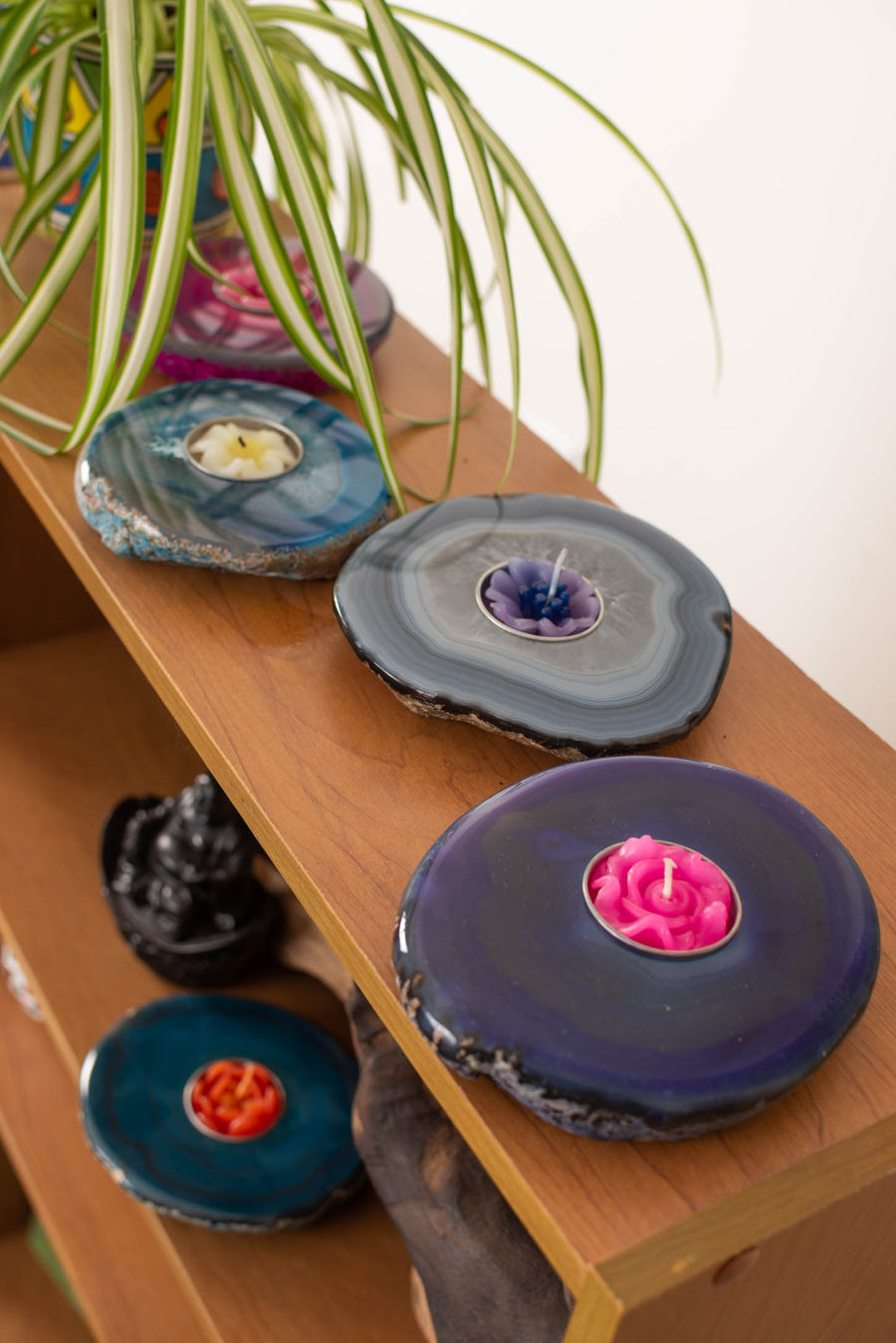 Polished agate tea light holders in purple, teal, blue, and pink