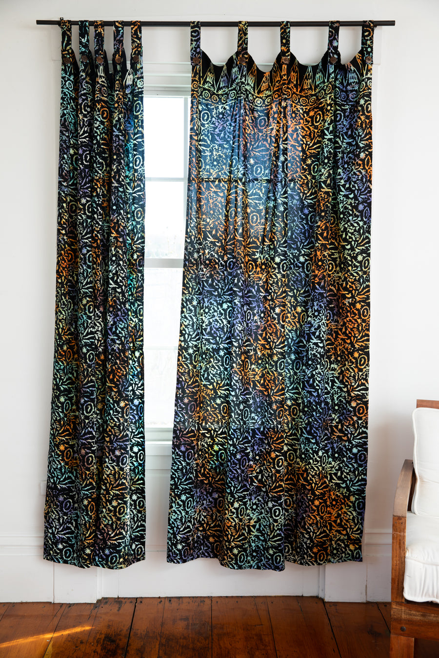 Batik curtains in sunlit shadows