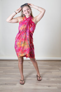 Sophie is wearing a batik sarong in crimson fan palm