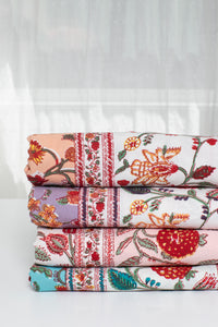 Block print floral tapestries in peach, lavender, pink, and turquoise