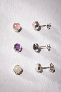 Gemstone earring stud trio in the theme of Goddess. The studs are Rainbow Moonstone, Rose Quartz, and Amethyst