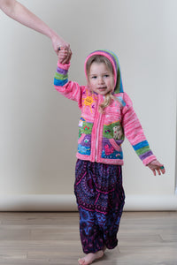 Aurora is wearing a kids nature scene sweater in pink