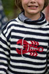 Phoenix is wearing a kids lobster sweater