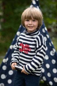 Phoenix is wearing a kids lobster sweater